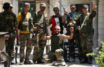 Members of Syria security forces pose for photographers in the al-Midan area in Damascus on July 20, 2012.jpeg